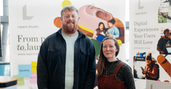 Layers Studio owners pose in front of their stand at an event